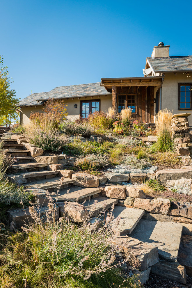 This is an example of a rustic full sun garden in Other with a garden path and natural stone paving.