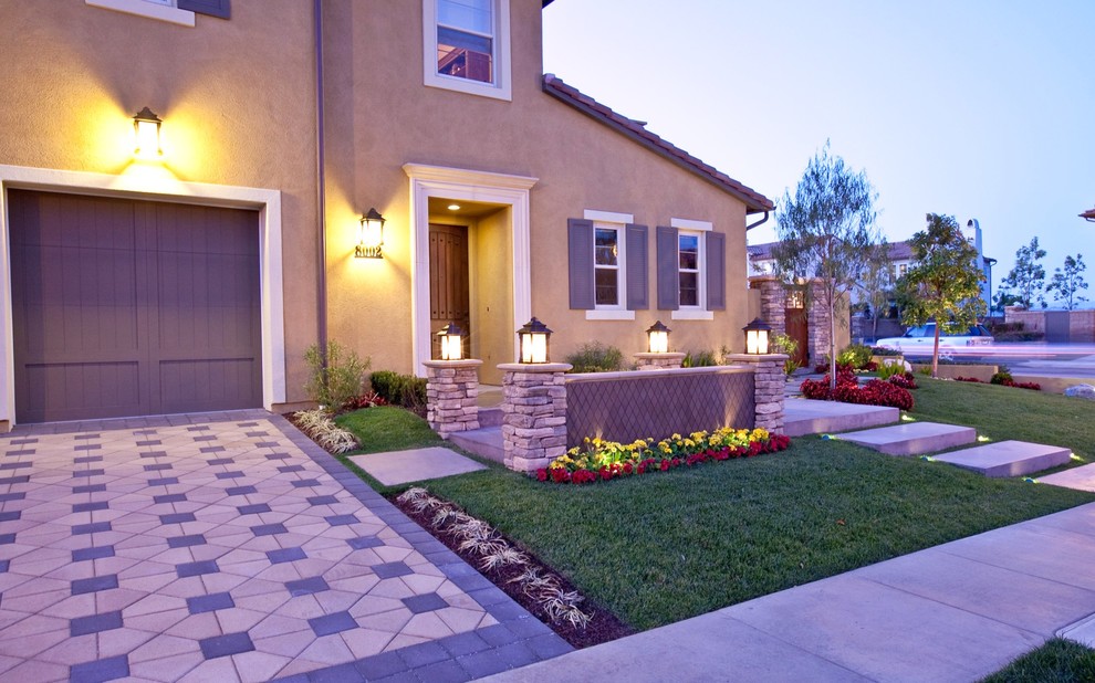 This is an example of a small eclectic full sun front yard concrete paver landscaping in Los Angeles.