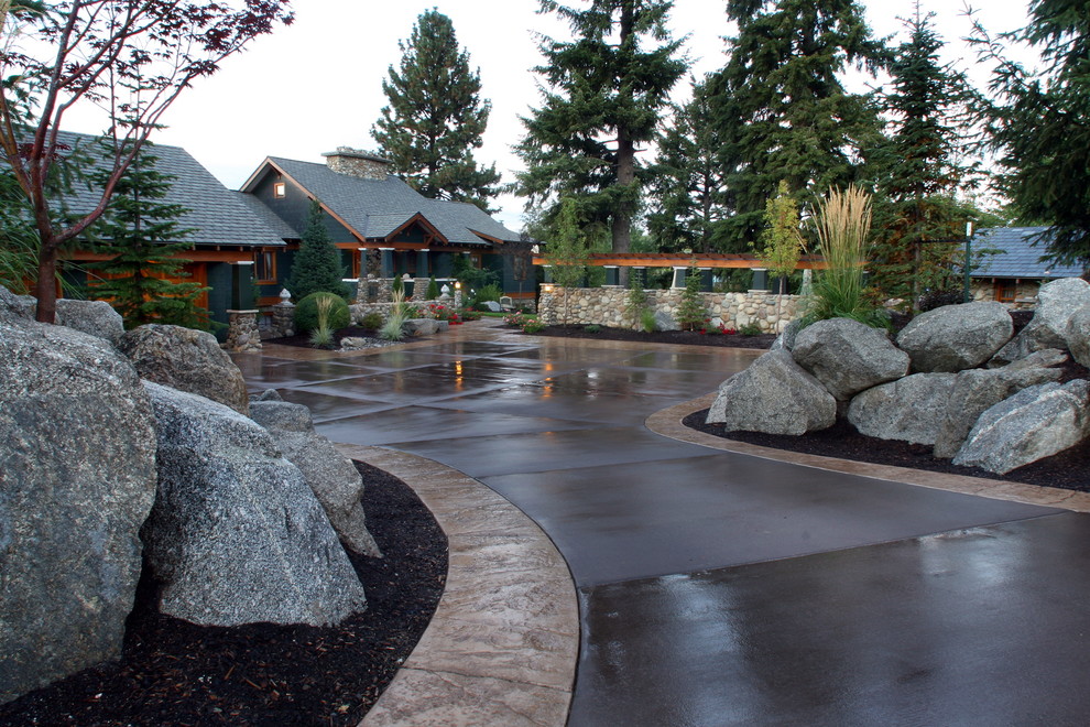 Photo of a large traditional front yard stone driveway in Seattle.
