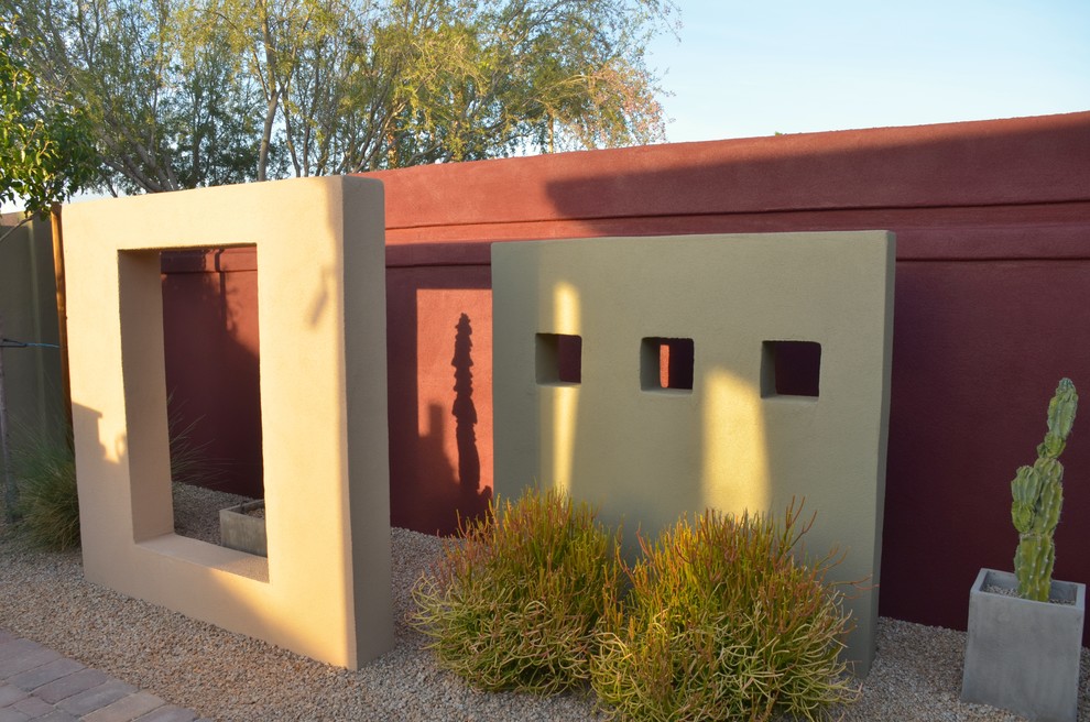 This is an example of a small eclectic back partial sun garden in Phoenix with concrete paving.