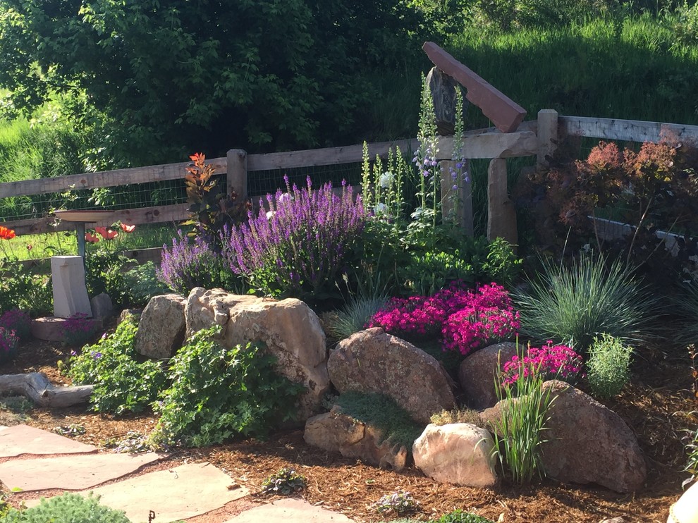Inspiration for a large eclectic drought-tolerant, full sun and rock backyard stone landscaping in Denver.