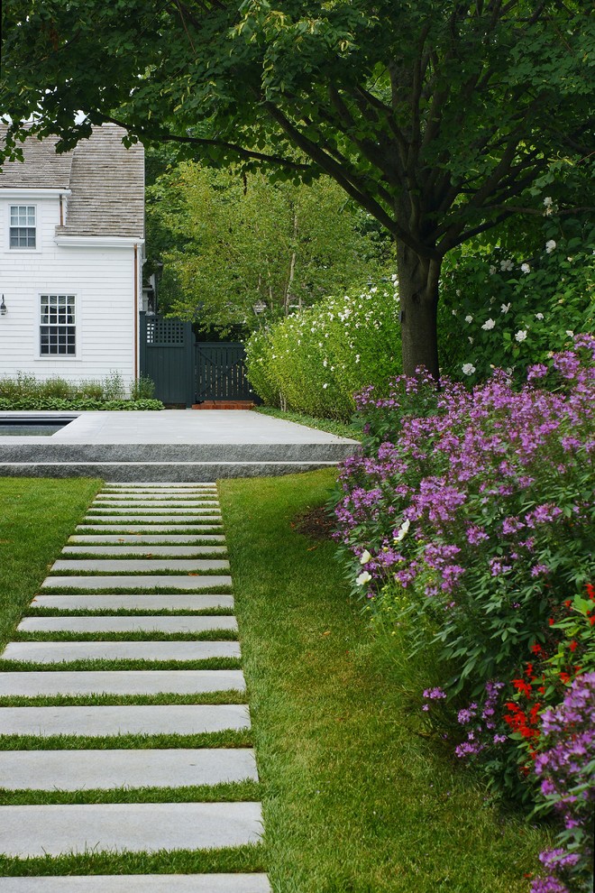 На фото: солнечный, летний участок и сад среднего размера на заднем дворе в классическом стиле с хорошей освещенностью и покрытием из каменной брусчатки