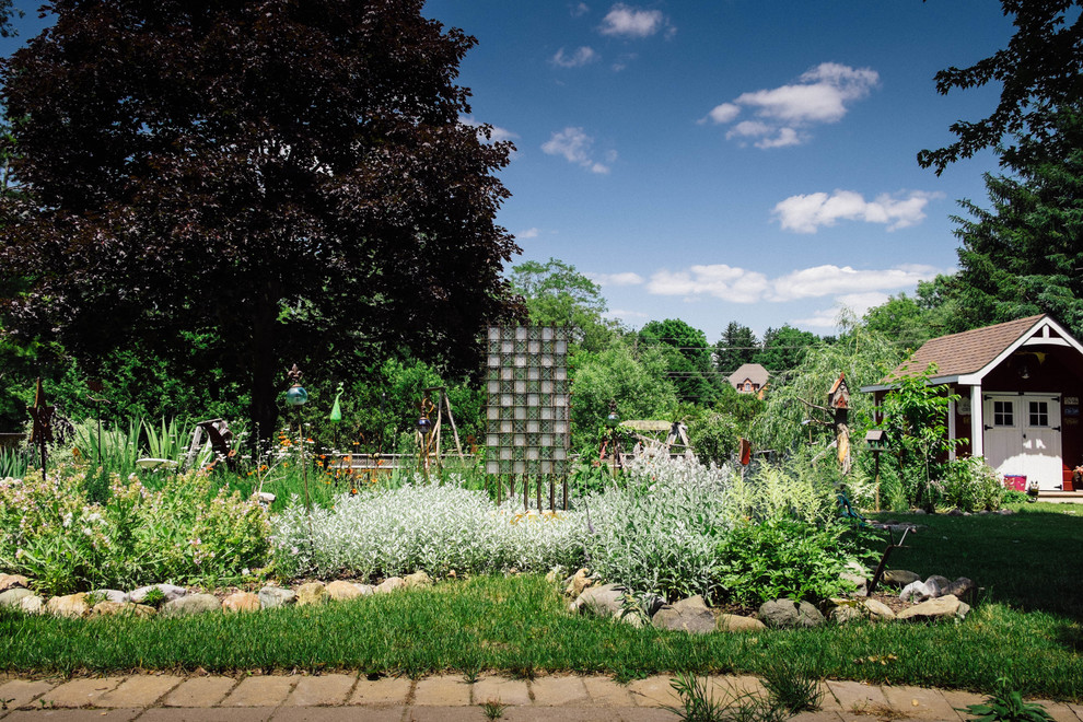 Design ideas for a large romantic back formal full sun garden for summer in Toronto with a vegetable patch.