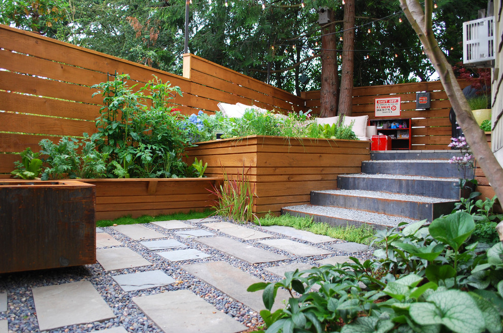 Small modern courtyard partial sun garden in Seattle with a vegetable patch and natural stone paving.