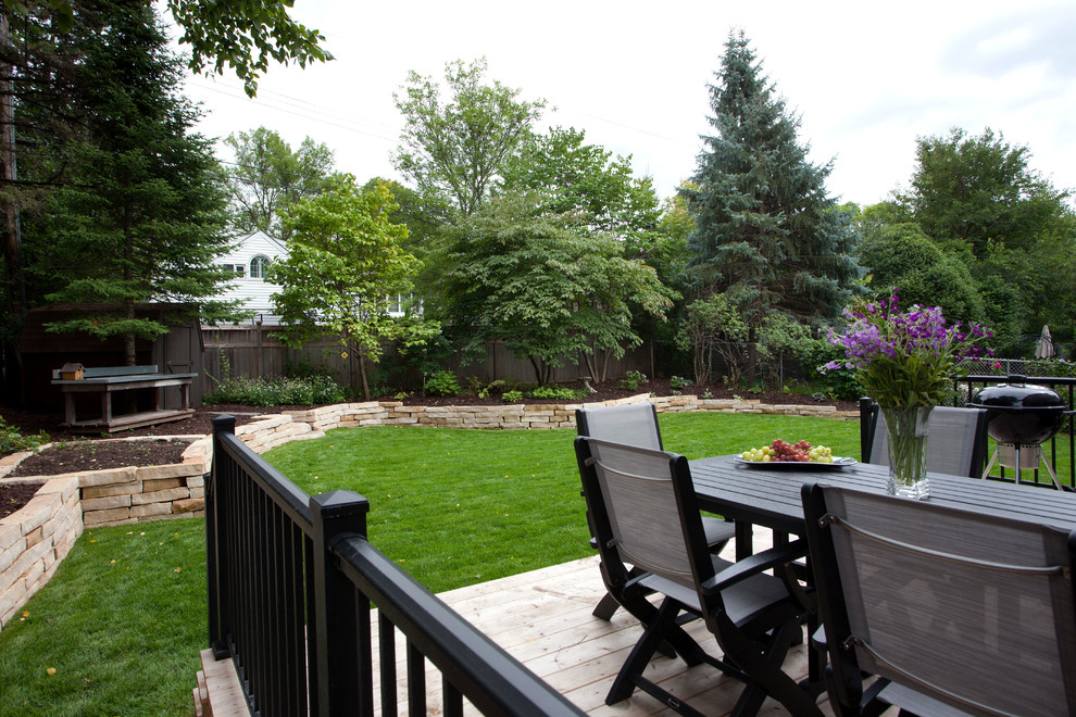 This is an example of a large eclectic full sun backyard formal garden in Minneapolis with decking for summer.