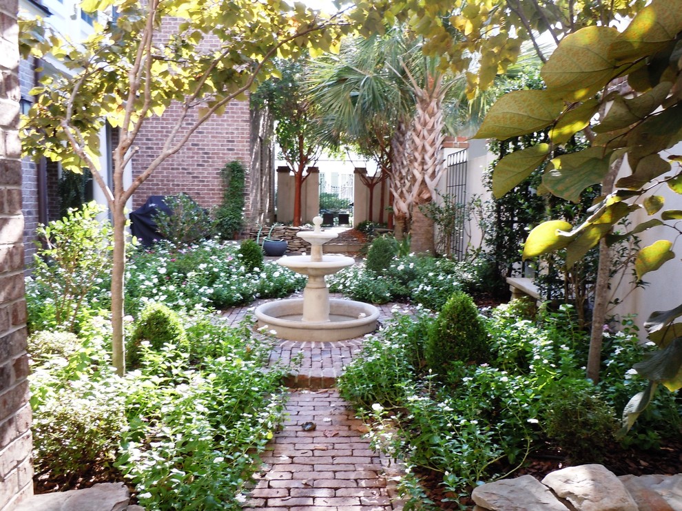 This is an example of a small contemporary courtyard stone water fountain landscape in Charleston for summer.