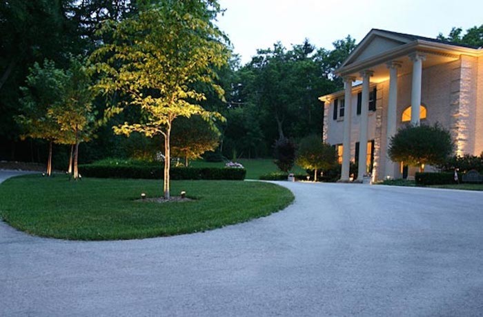 This is an example of a large traditional partial sun front yard concrete paver driveway in Milwaukee.