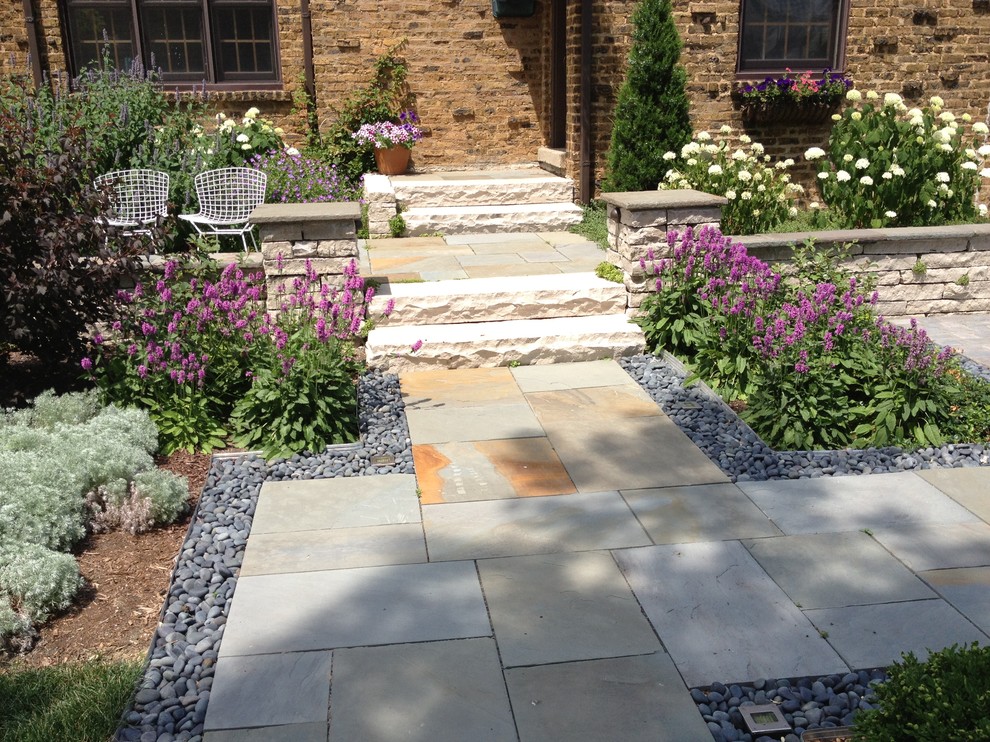 Photo of a mid-sized traditional full sun front yard stone landscaping in Chicago.