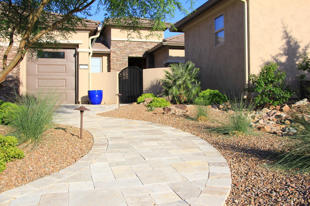 Inspiration for a mid-sized mediterranean drought-tolerant and full sun front yard stone landscaping in Phoenix for summer.