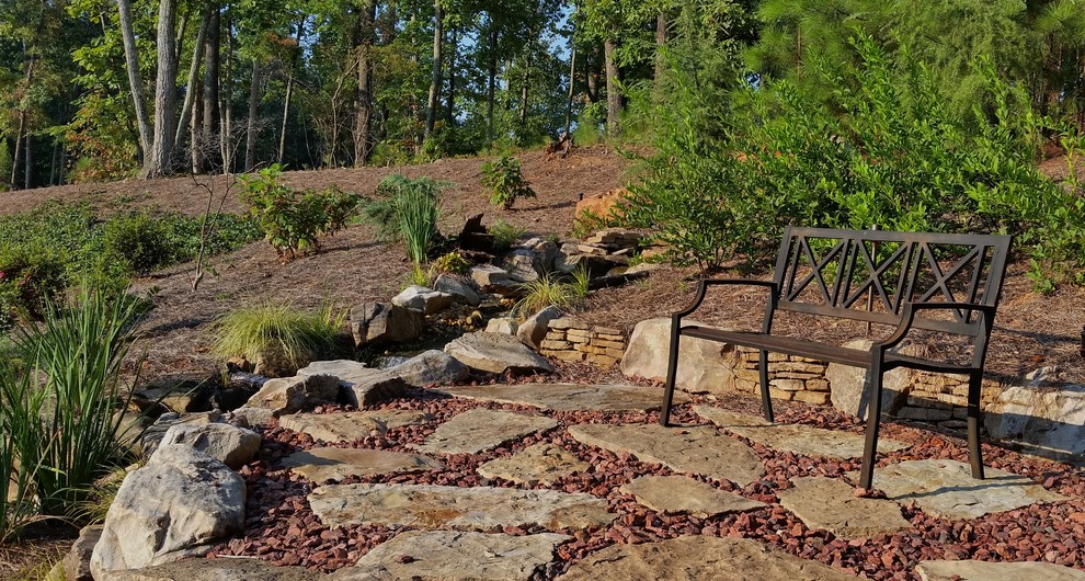 Design ideas for a mid-sized southwestern full sun backyard retaining wall landscape in Atlanta with decking.