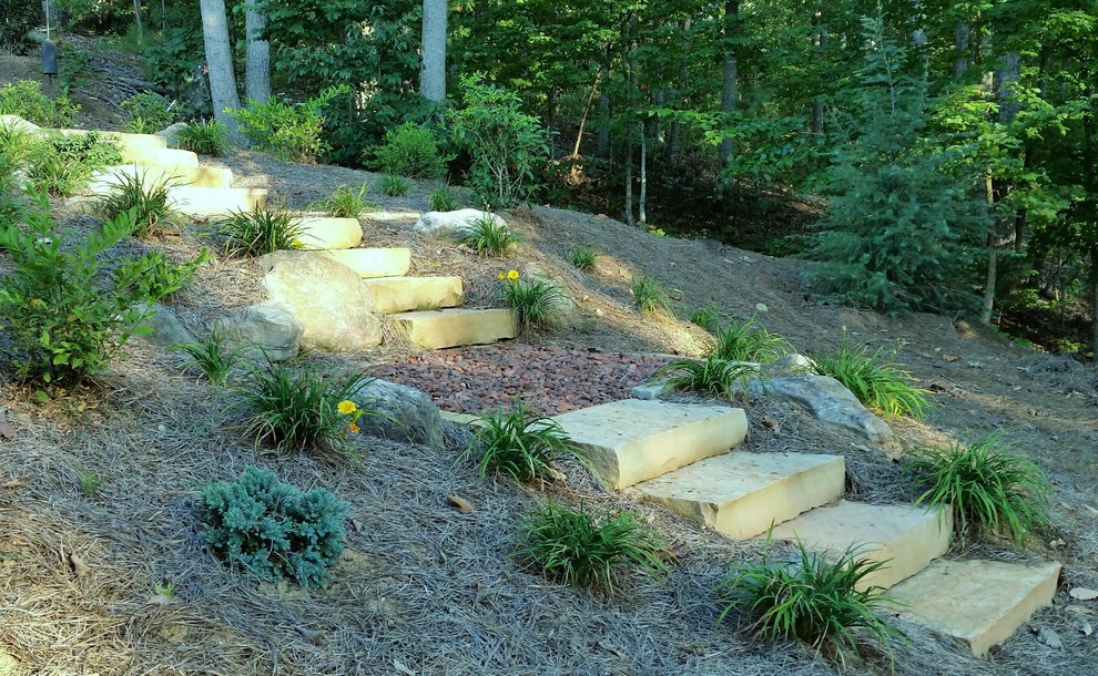 This is an example of a mid-sized southwestern full sun backyard water fountain landscape in Atlanta with decking.