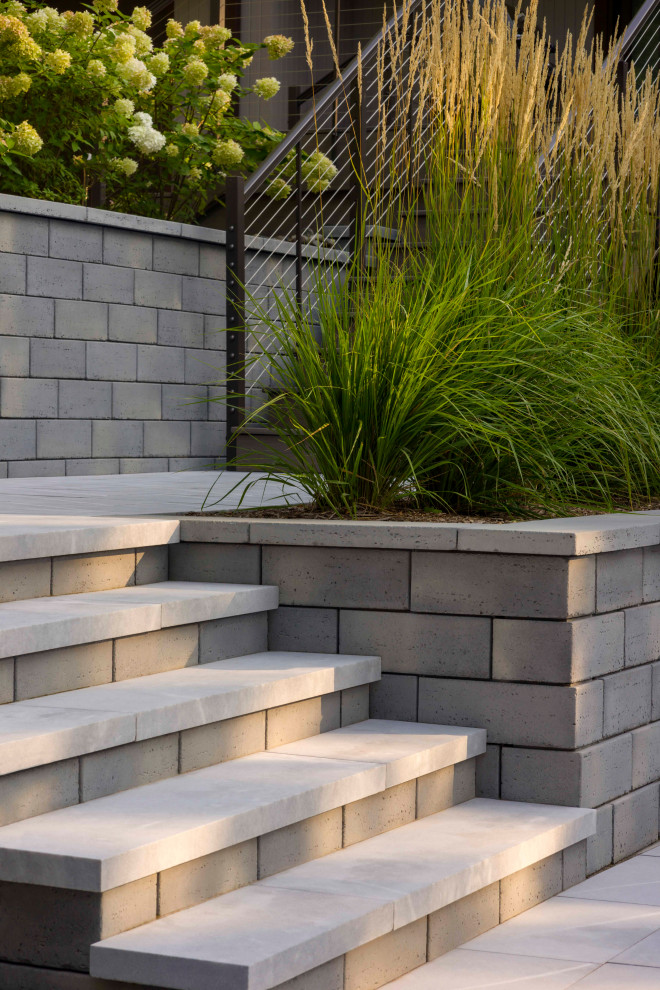 Inspiration for a modern front yard concrete paver landscaping in New York.