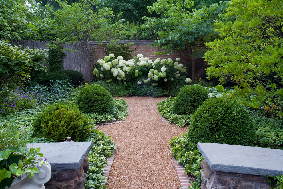 Inspiration for a large traditional shade backyard gravel formal garden in Chicago for summer.