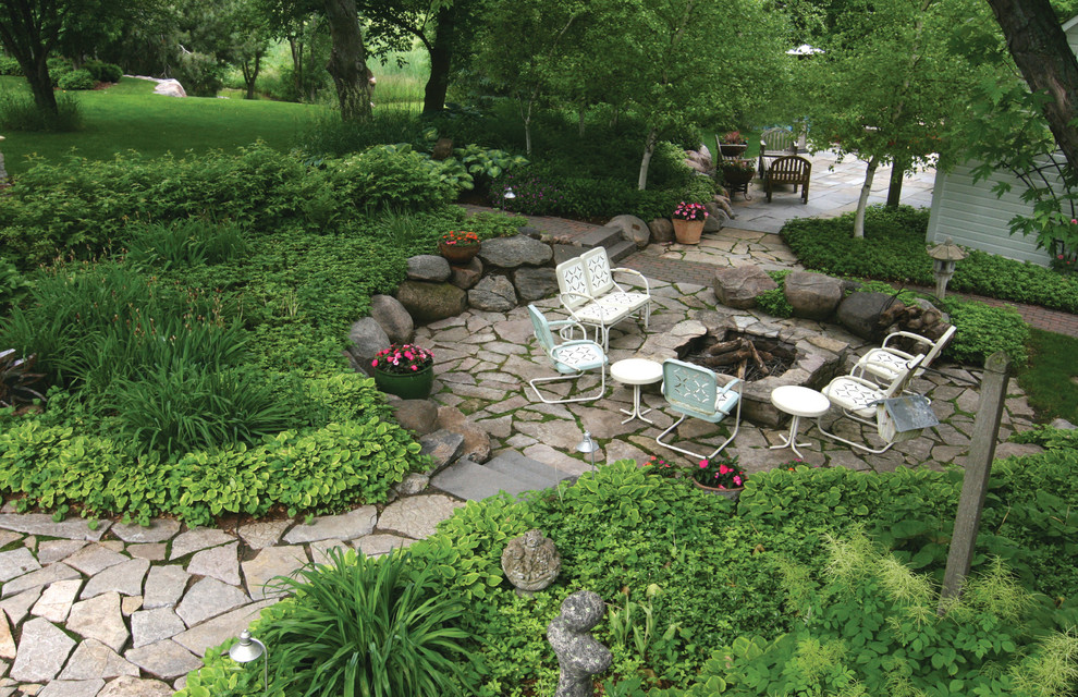 Design ideas for a large farmhouse partial sun backyard stone landscaping in Minneapolis with a fire pit.