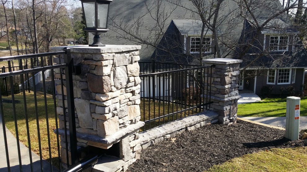 This is an example of a mid-sized traditional full sun backyard stone landscaping in Atlanta.