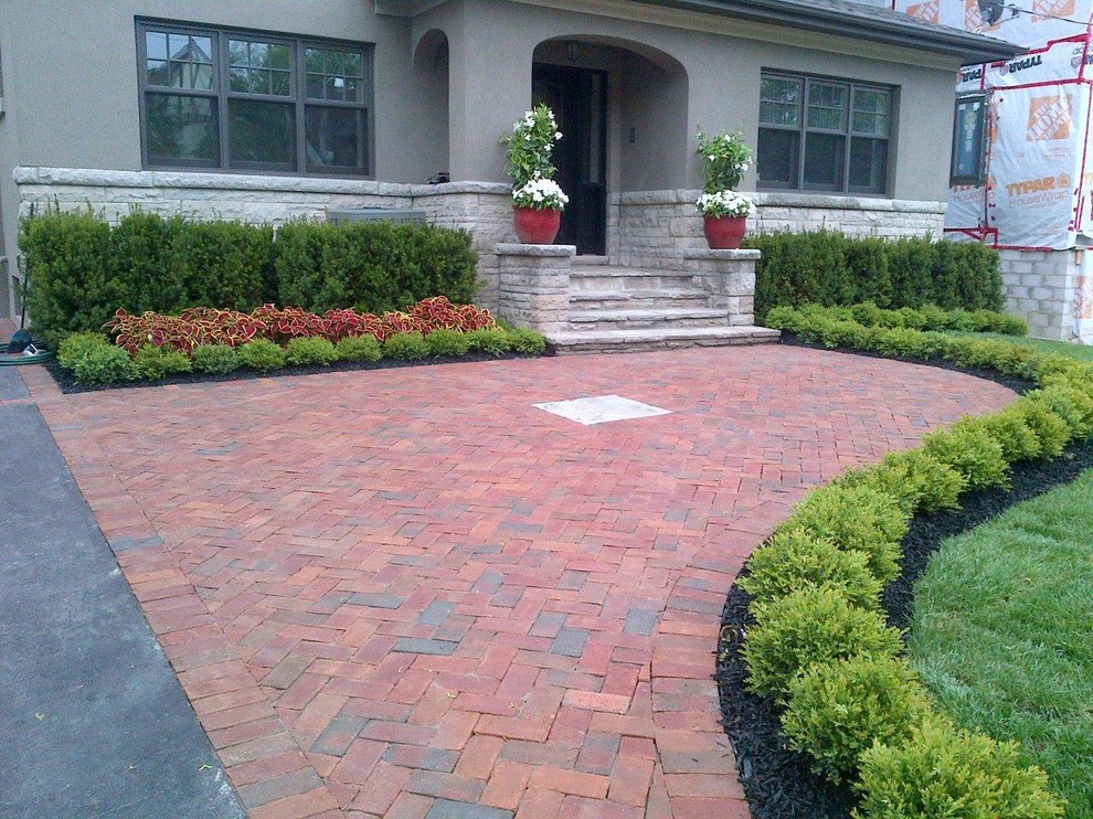 This is an example of a mid-sized traditional partial sun front yard brick formal garden in Toronto for summer.
