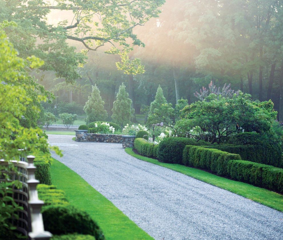 Photo of a mid-sized traditional full sun front yard gravel driveway in New York for summer.
