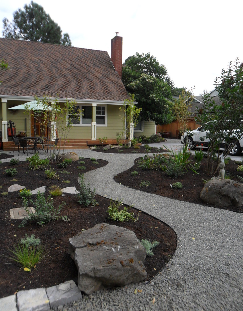 This is an example of a medium sized rural front xeriscape full sun garden in Portland with a garden path and gravel.