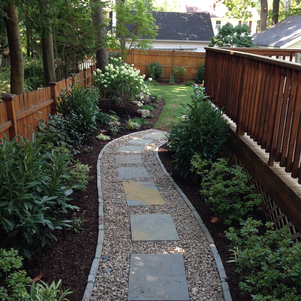 Photo of a mid-sized traditional shade backyard stone garden path in New York for spring.