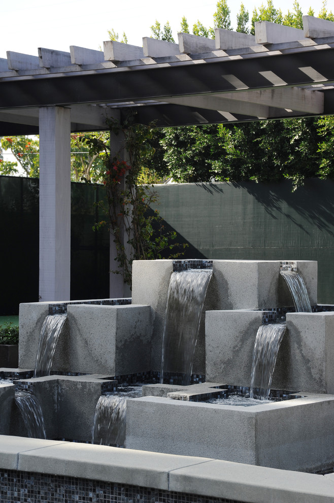 This is an example of a contemporary garden in Boston with a water feature.