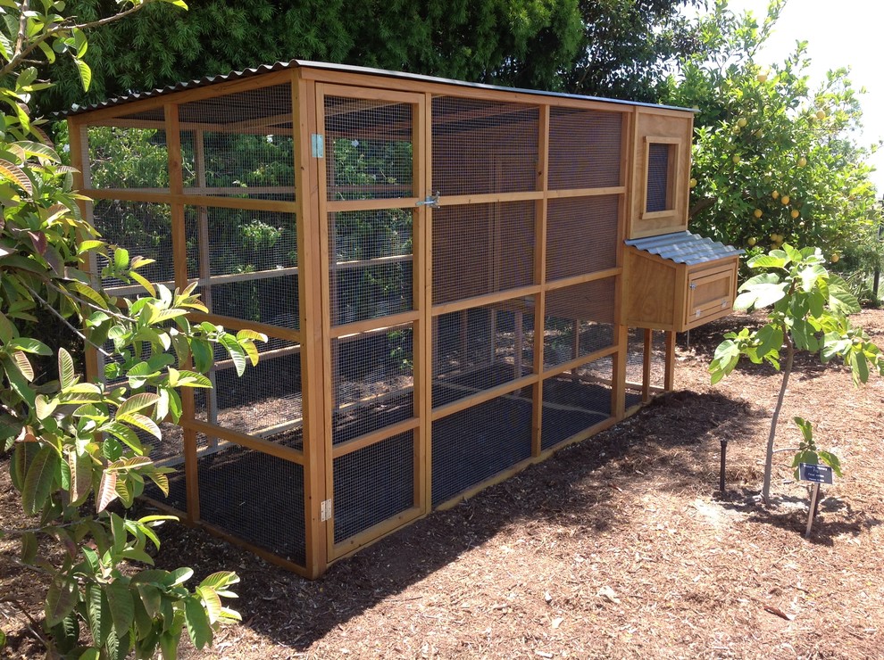 Design ideas for a mid-sized farmhouse full sun backyard gravel formal garden in San Diego.