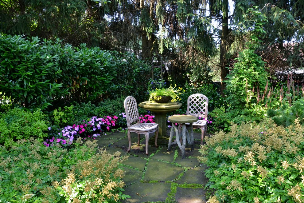 Inspiration for a mid-sized shabby-chic style partial sun backyard concrete paver formal garden in New York for summer.