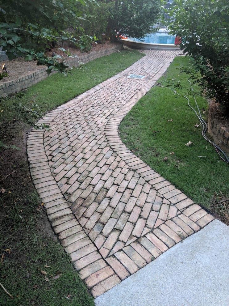 Medium sized classic back garden in Atlanta with brick paving.
