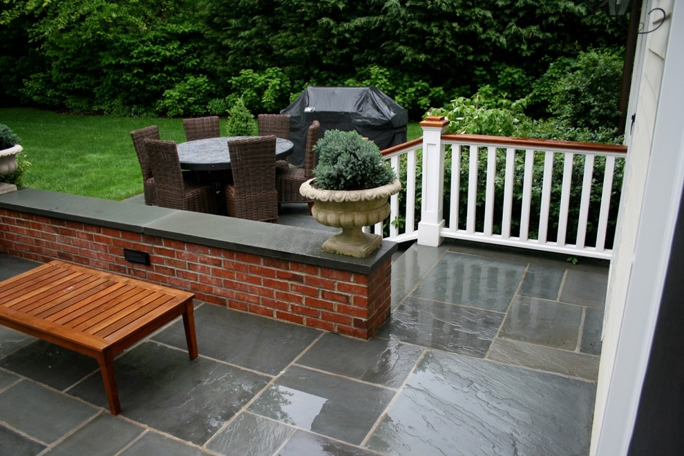 Photo of a mid-sized full sun courtyard concrete paver landscaping in New York.