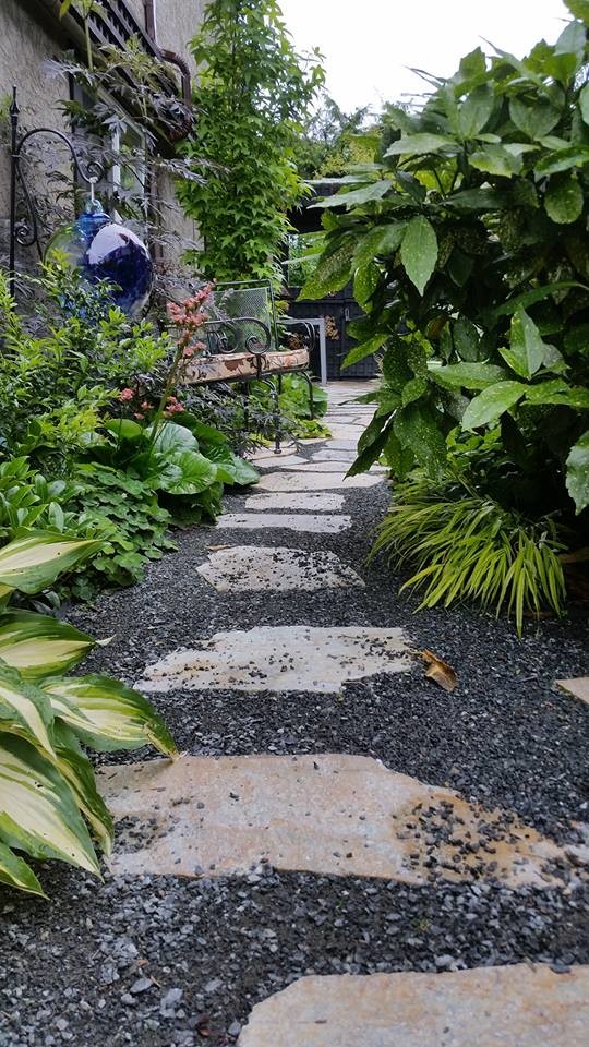 Design ideas for a small rustic partial sun side yard stone garden path in Other.