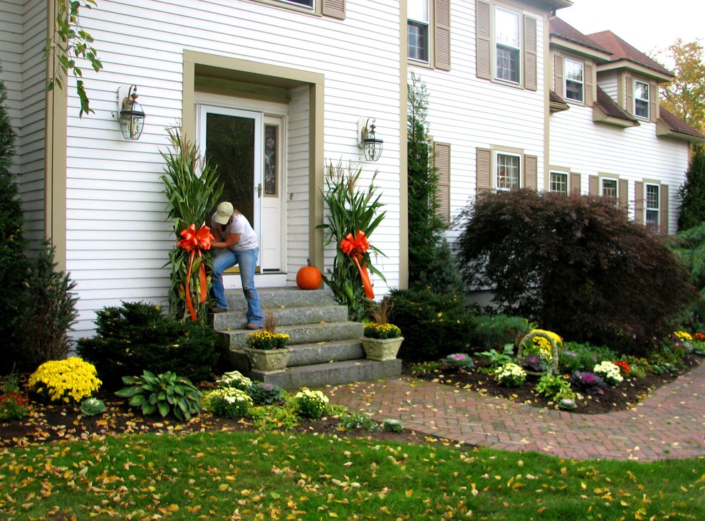 This is an example of a traditional partial sun front yard landscaping in Boston for fall.
