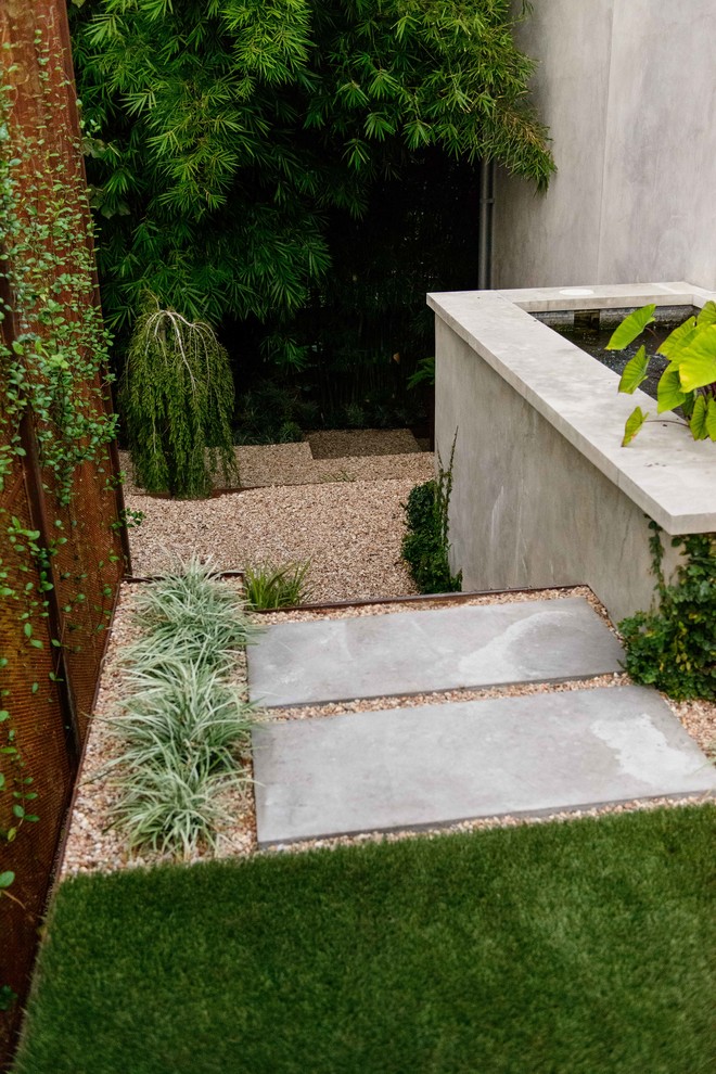 Exemple d'un jardin à la française latéral moderne de taille moyenne et au printemps avec une exposition partiellement ombragée, du gravier et un bassin.