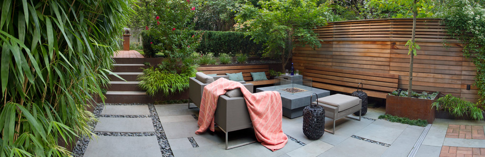 This is an example of a mid-sized modern full sun backyard gravel landscaping in Toronto for winter.