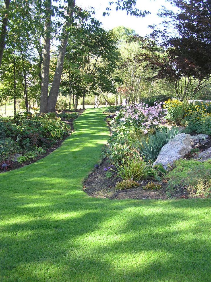 This is an example of a traditional shade backyard landscaping in Manchester.