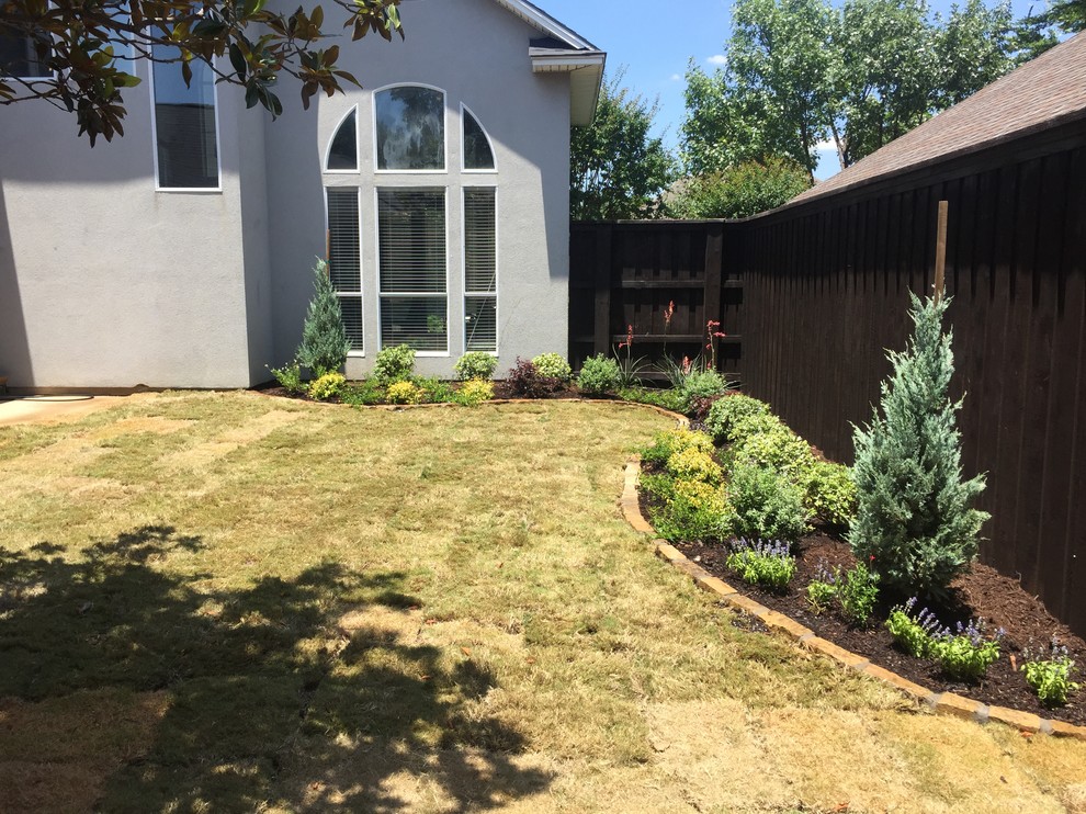 Diseño de jardín clásico de tamaño medio en verano en patio trasero con exposición total al sol y adoquines de piedra natural