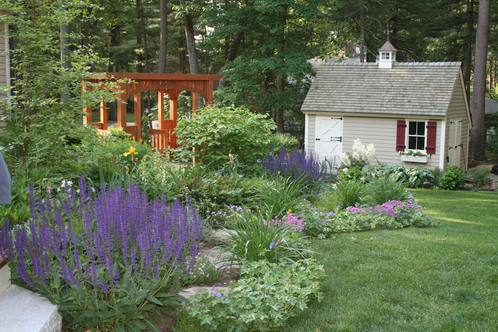 Design ideas for a large farmhouse shade backyard stone garden path in Other for summer.