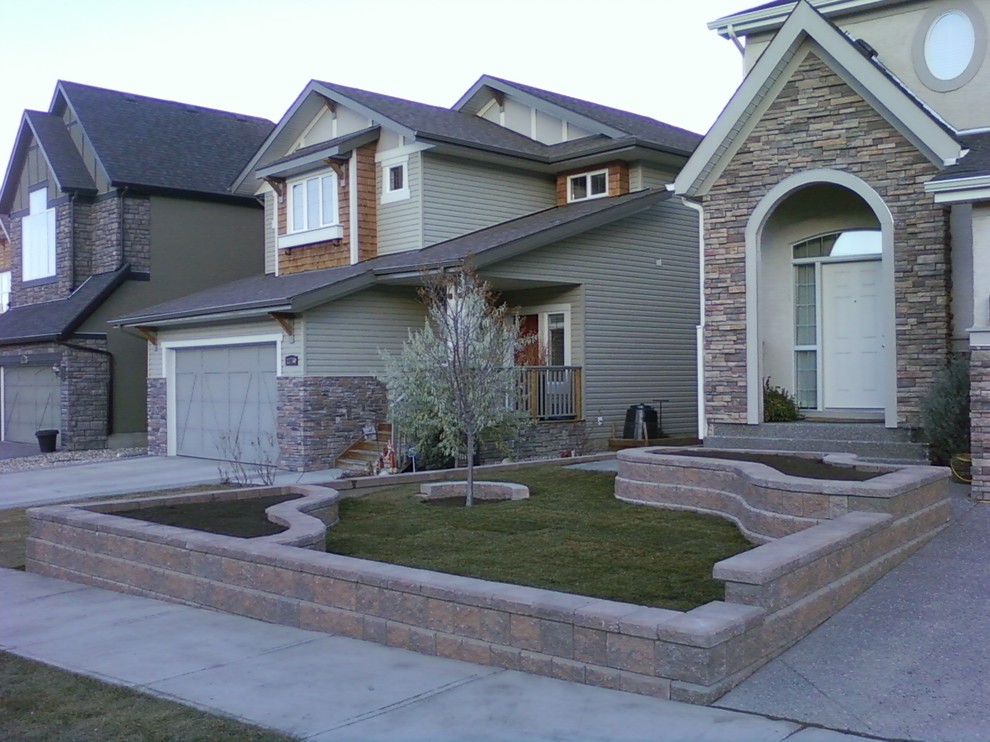 Inspiration for a medium sized contemporary back garden in Calgary with a retaining wall and concrete paving.