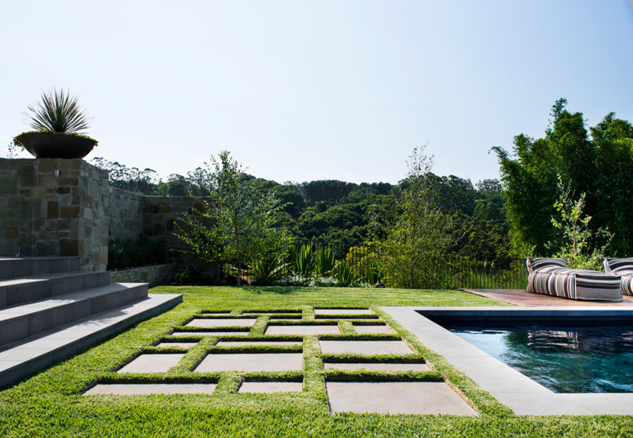 This is an example of an expansive classic back formal full sun garden in Sydney.