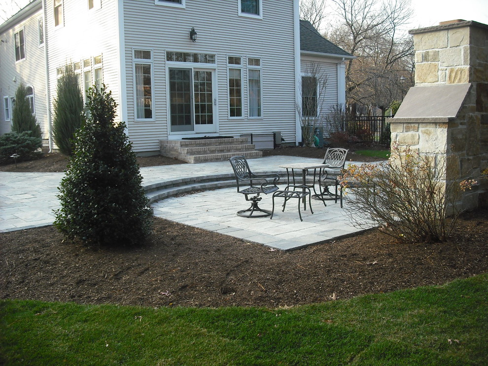 Design ideas for a medium sized classic back partial sun garden in Boston with concrete paving and a fire feature.