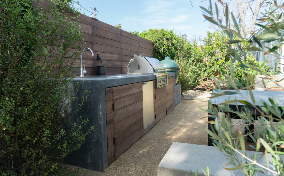 Inspiration for a large modern partial sun backyard gravel landscaping in Los Angeles with a fire pit.