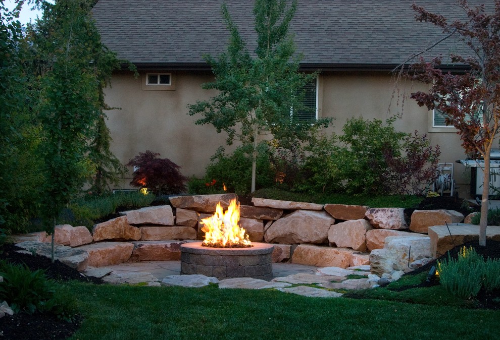 Cette photo montre un jardin arrière sud-ouest américain avec un foyer extérieur et des pavés en pierre naturelle.