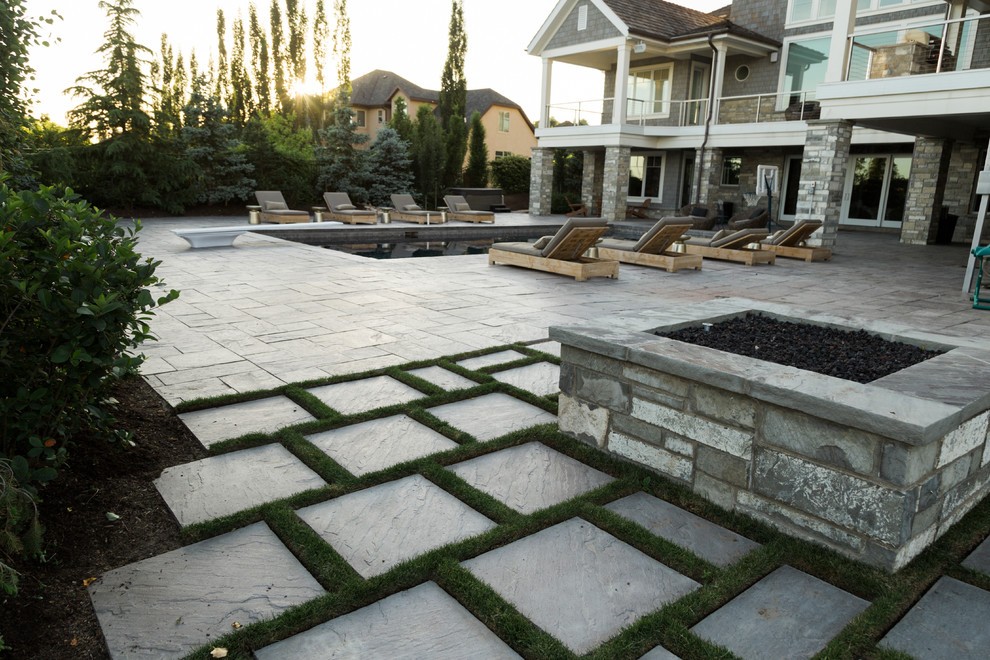 This is an example of a traditional back garden in Salt Lake City with a fire feature and concrete paving.