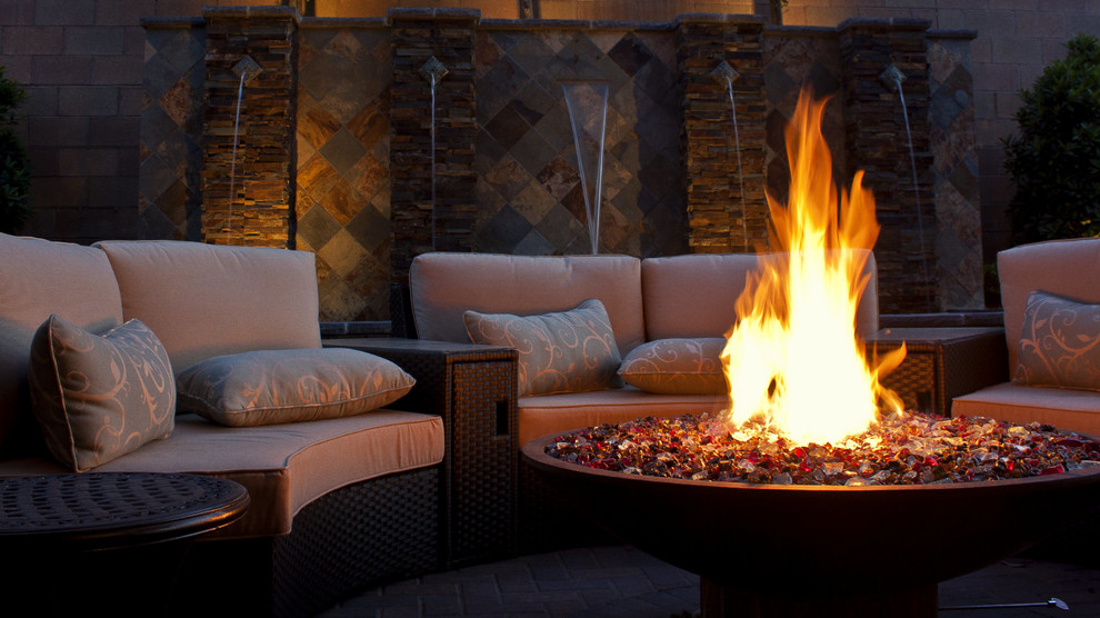 Inspiration for a medium sized contemporary back patio in Las Vegas with a fire feature and concrete paving.