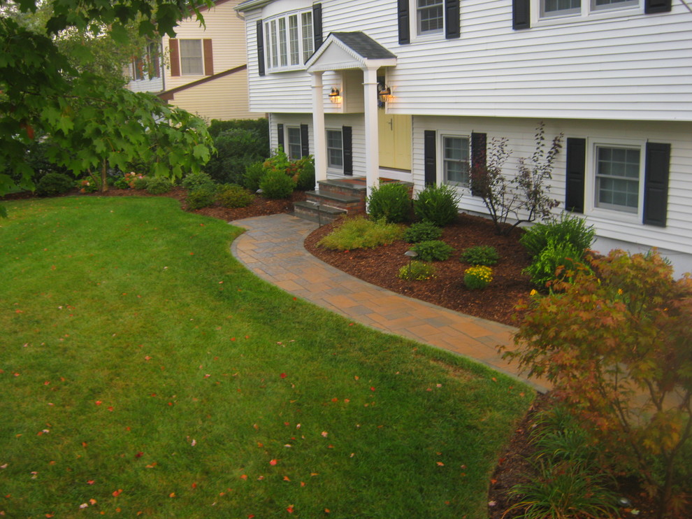 Photo of a medium sized classic front garden in New York with a garden path and natural stone paving.