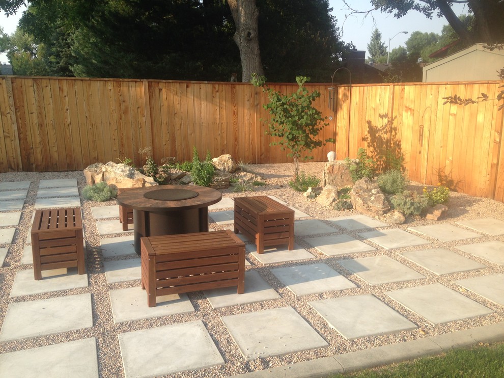 Photo of a medium sized contemporary back xeriscape partial sun garden for summer in Denver with a fire feature and concrete paving.