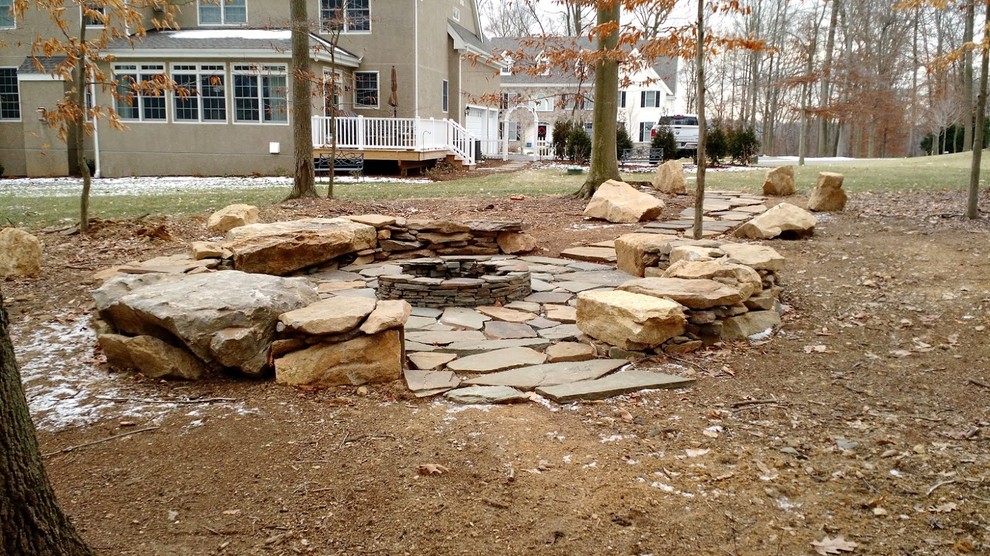 Photo of a small rustic back fully shaded garden in Philadelphia with a fire feature and natural stone paving.