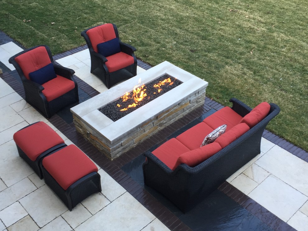 Mid-sized trendy backyard stone patio photo in Chicago with a fire pit