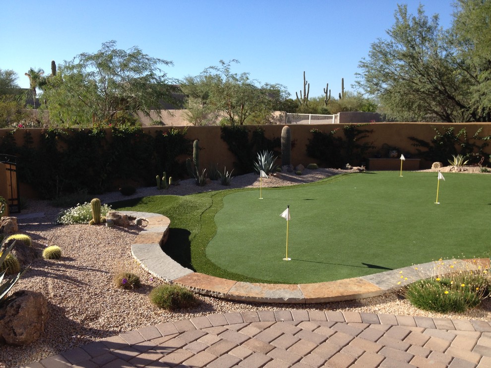 Photo of a large southwestern drought-tolerant and full sun backyard stone landscaping in Phoenix.