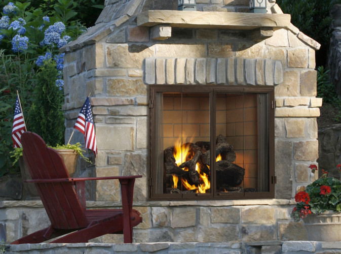 Inspiration for a medium sized classic back patio in Minneapolis with a fire feature and natural stone paving.