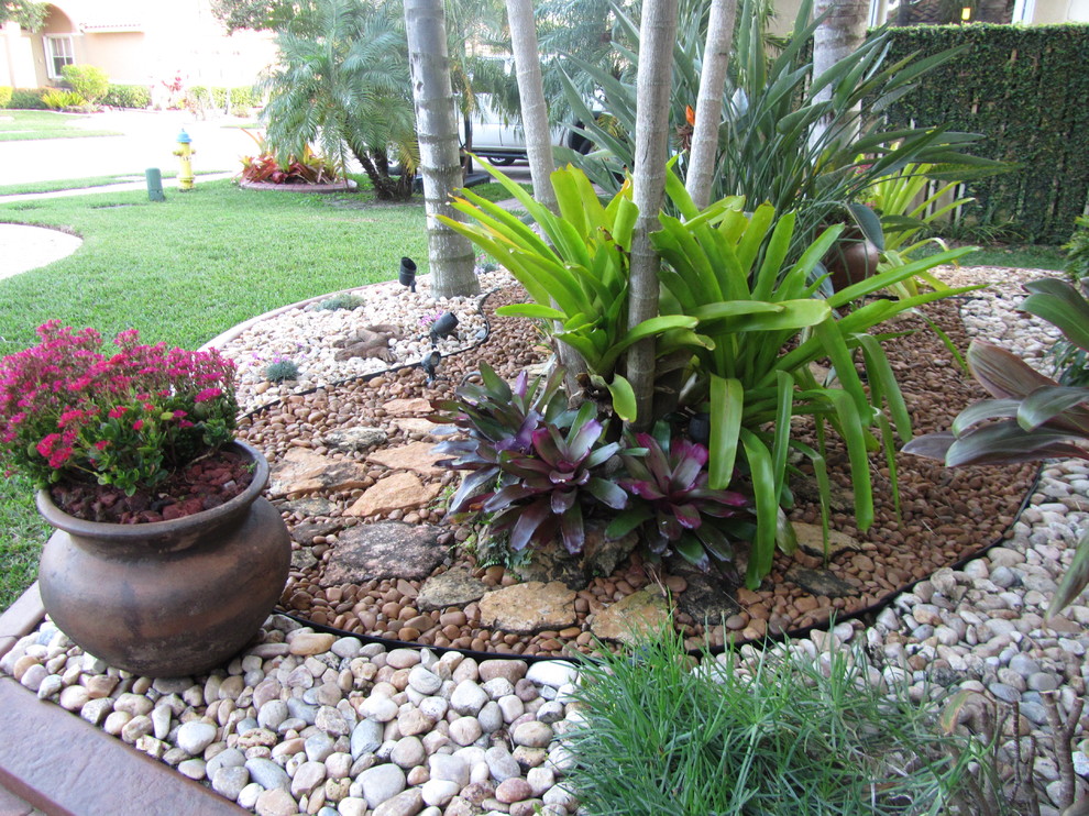 This is an example of an eclectic river rock landscaping in Miami.
