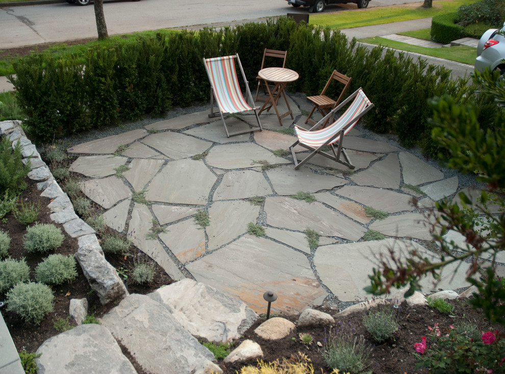 This is an example of a large contemporary full sun front yard stone garden path in Vancouver.